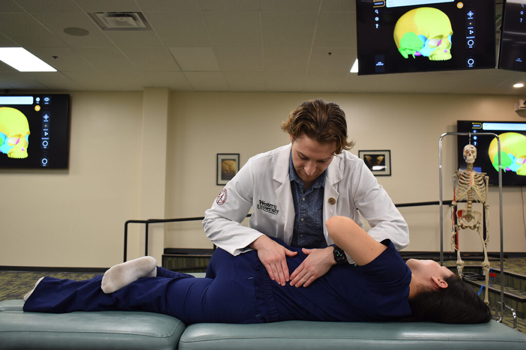 A doctor is examining a patient's back.